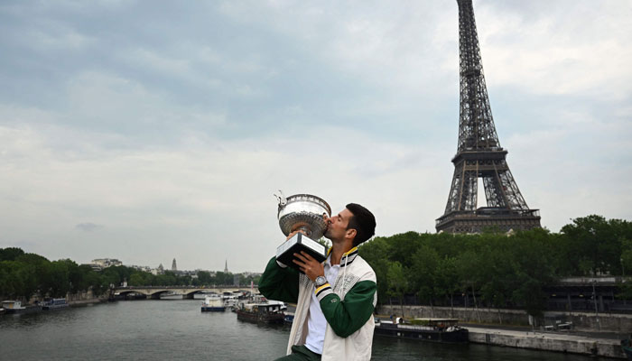 Novak Djokovic kisses the Trophy during a photocall after winning the Roland-Garros French Open tennis tournament, in Paris, on June 12, 2023. — AFP  